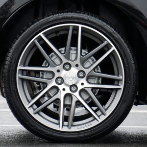 pexels photo 244553 244553 Detailed shot of a sleek car wheel and rim on a black vehicle, showcasing automotive design.